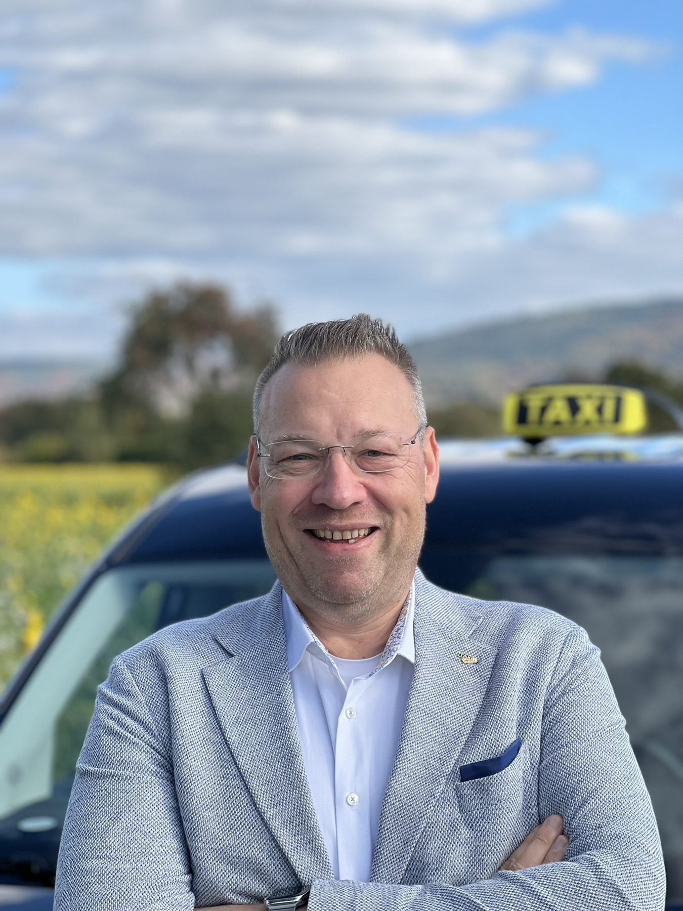 Porträt von Dirk Holl, im Hintergrund ein Taxischild